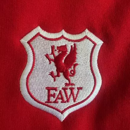 embroidered logo on a red background