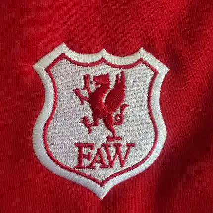 embroidered logo on a red background